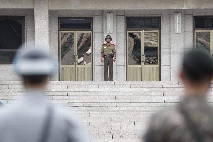 In this file photo, a North Korean soldier, centre, and South Korean soldiers face each other at the Joint Security Area in the border village Panmunjom, South Korea, 27 July 2017.