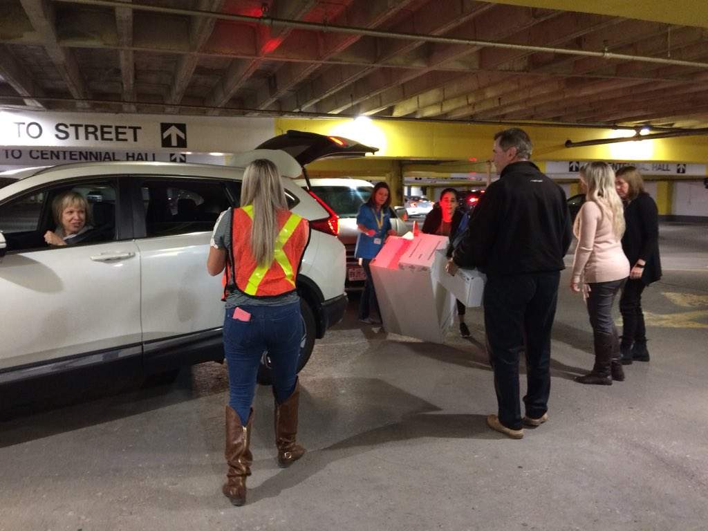 Election volunteers return tabulators and ballot boxes to city hall. Memory cards from the tabulators need to be removed, sorted, and counted before any results are announced. 