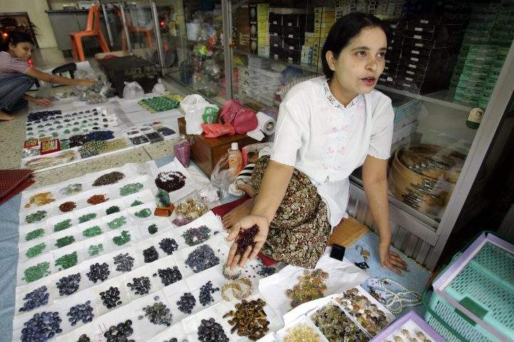 A woman from Myanmar sells rubies and other semi-precious stones at a market in this Oct. 21, 2007, file photo in Mae Sot, Thailand.