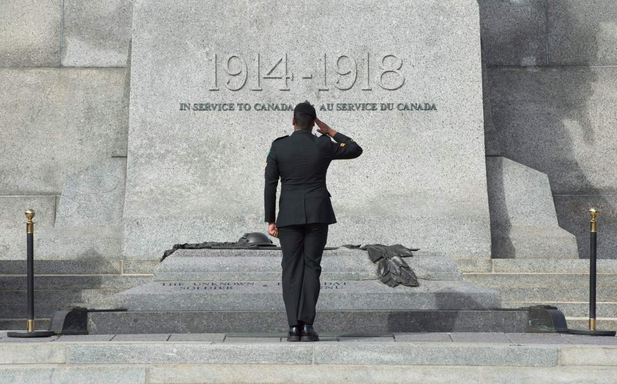 A member of the Canadian Forces salutes as he passes in front of the Tomb of the Unknown Soldier  at the National War Memorial in Ottawa, Wednesday Oct. 22, 2015.