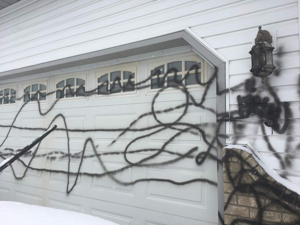 The front of the Airdrie home was targeted with black spray paint.