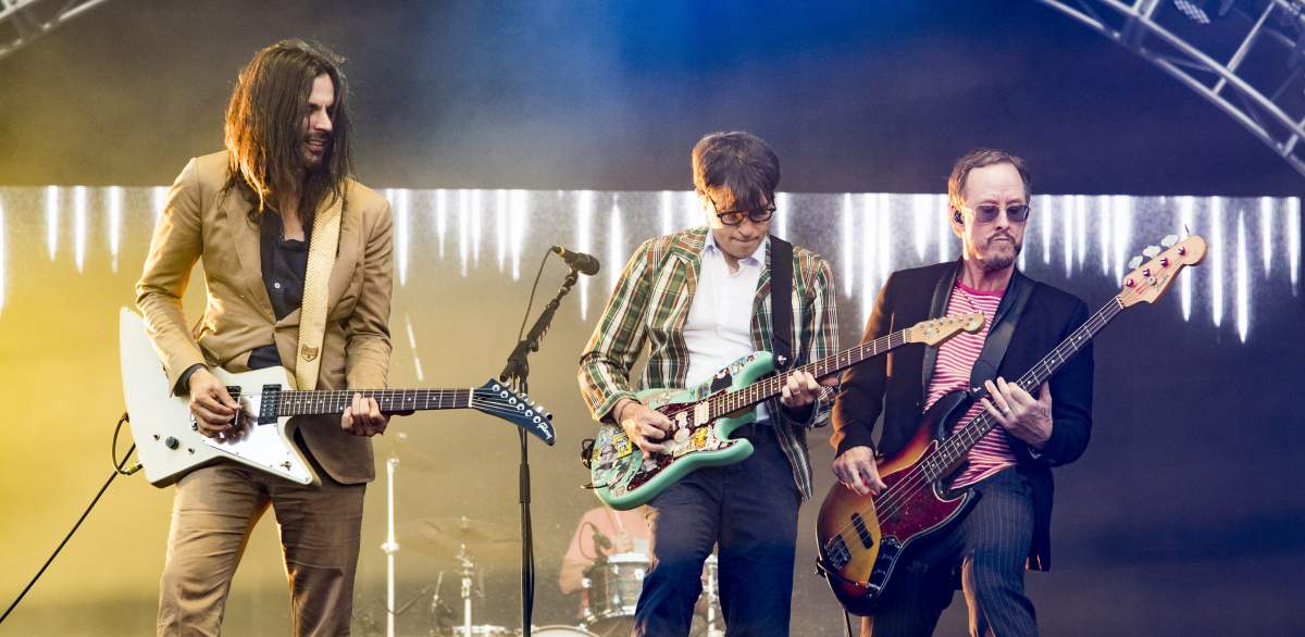 (L-R) Brian Bell, Rivers Cuomo and Scott Shriner of Weezer perform at the Del Mar Fairgrounds on Sept. 15, 2017, in Del Mar, Calif.