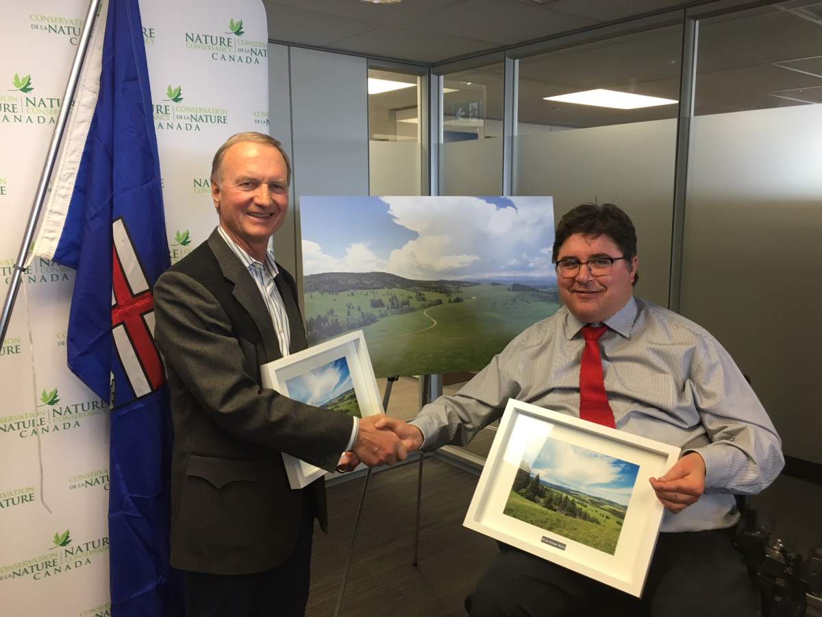 Stan Carscallan, pictured with Calgary Centre MP Kent Hehr, donated his White Moose Ranch property to the Nature Conservancy of Canada.