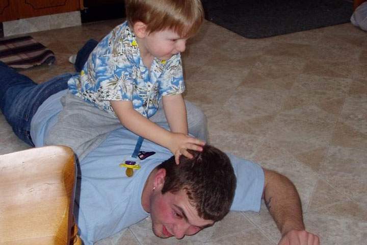 Jacob Cenerini-Palmer, 3, sitting on Pte. Thomas Welch’s back (in March 2004). Thomas was 22 when he died by suicide.