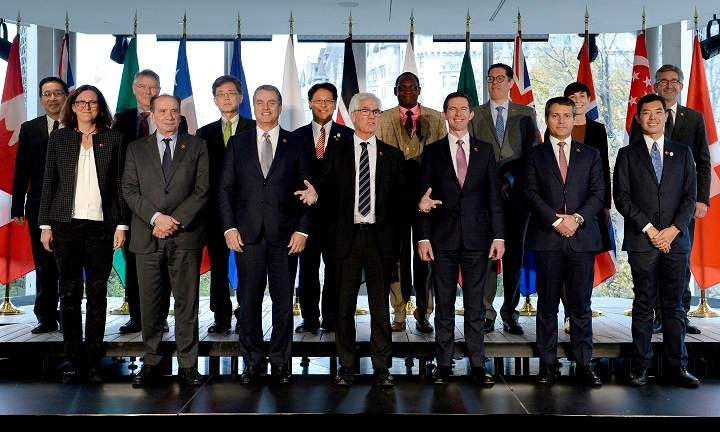 Canada's Minister of International Trade Diversification Jim Carr speaks as delegates pose for a family photo at the Ottawa Ministerial on WTO Reform, in Ottawa on Thursday, Oct. 25, 2018. 