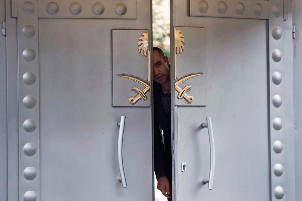 A security personnel looks out from the entrance of the Saudi Arabia’s consulate in Istanbul, Sunday, Oct. 14, 2018.