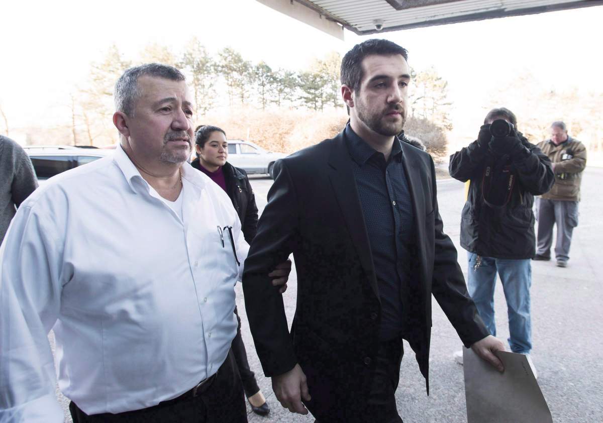 Marco Muzzo, right, arrives with family at the court house for his sentencing hearing in Newmarket, Ont., on February 23, 2016.