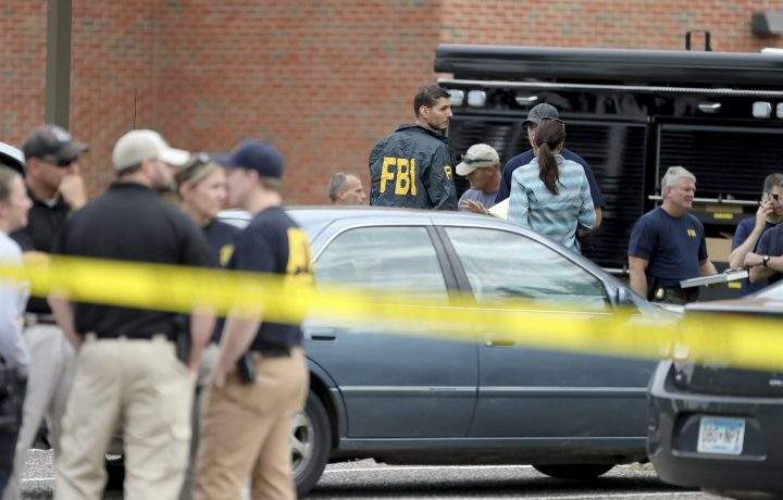 Law enforcement officials investigate an explosion at the Dar Al-Farooq Islamic Center in Bloomington, Minn., on Saturday, Aug. 5, 2017. 