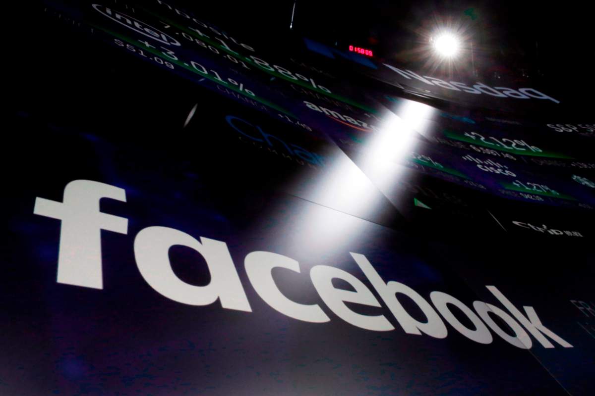 In this March 29, 2018, file photo the logo for Facebook appears on screens at the Nasdaq MarketSite in New York's Times Square. 