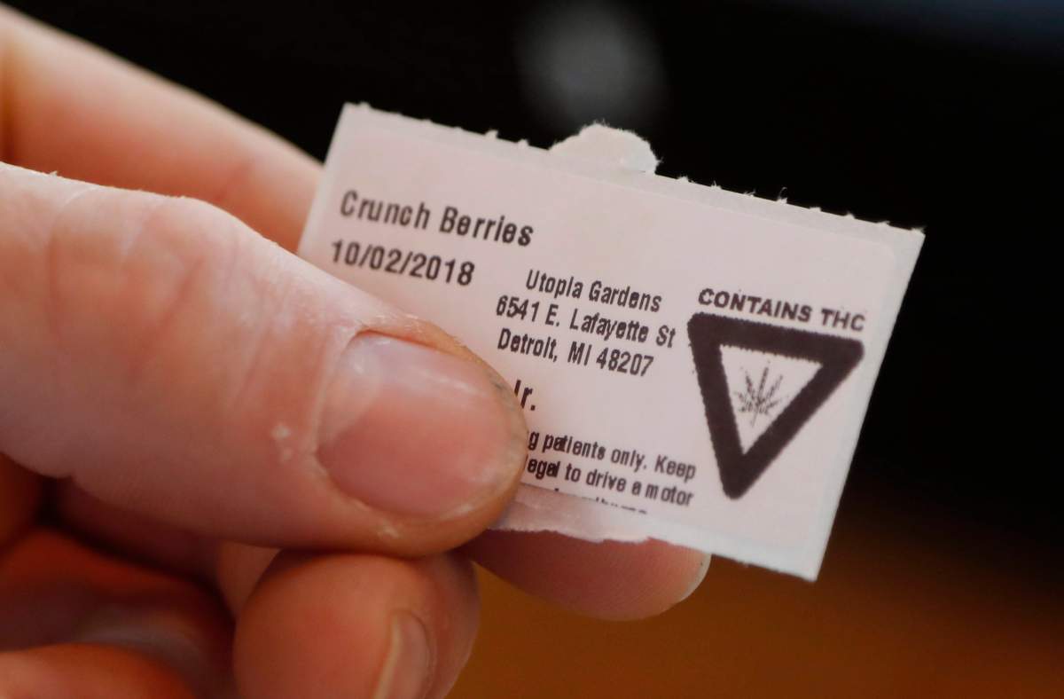 In this Tuesday, Oct. 2, 2018, photo, a warning label from Utopia Gardens, a medical marijuana dispensary, is shown in Detroit.