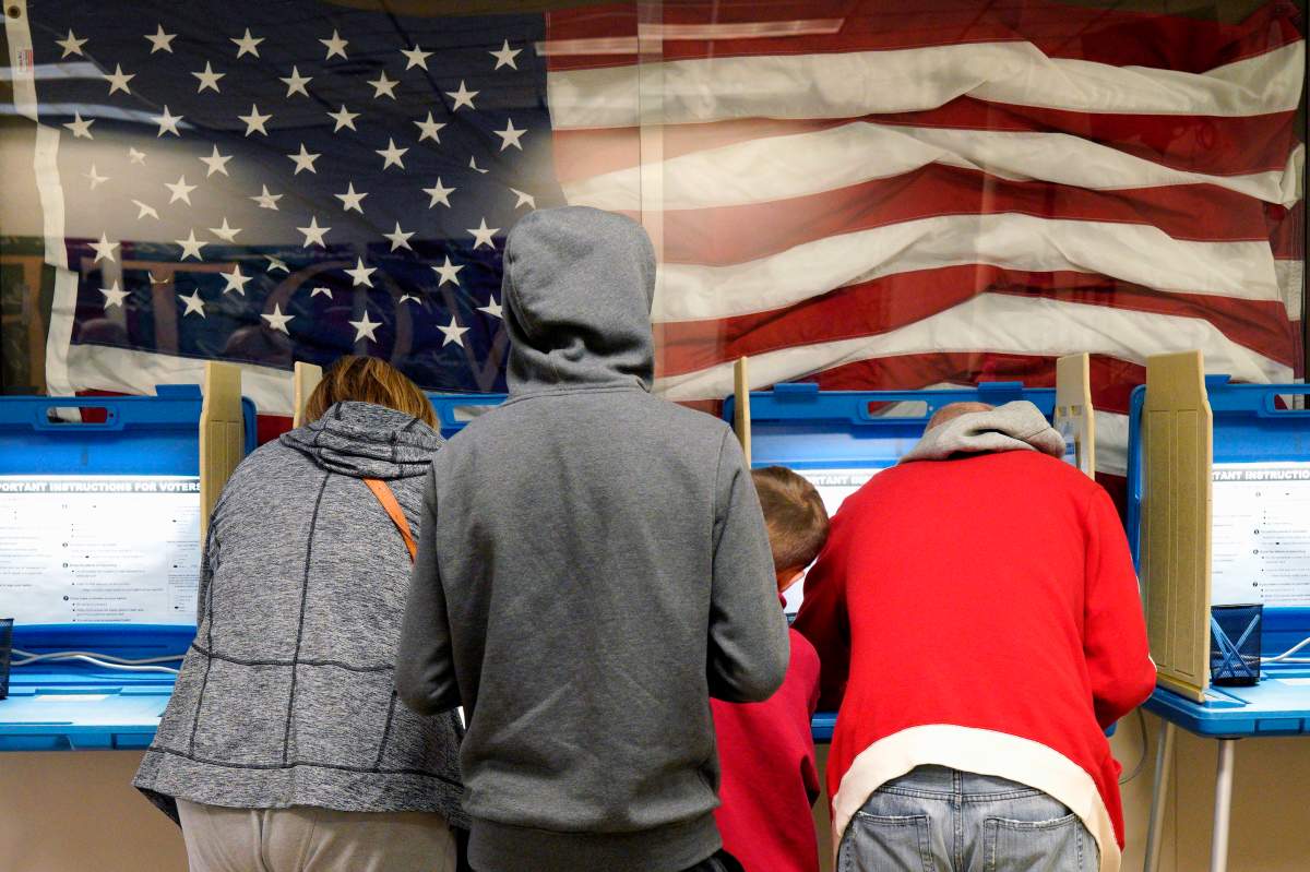 FILE- In this Nov. 2, 2018, file photo residents vote early at the Douglas County Election Commission office in Omaha, Neb. (AP Photo/Nati Harnik, File).