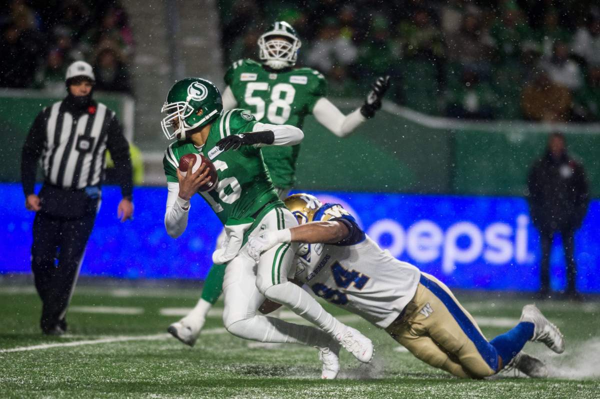 Saskatchewan Roughriders quarterback Brandon Bridge (16) is brought down by Winnipeg Blue Bombers defensive end Jackson Jeffcoat (94) during second half CFL action in Regina.  The Winnipeg Blue Bombers defeated the Saskatchewan Roughriders 23-18 on Sunday, Nov 11, 2018.  
