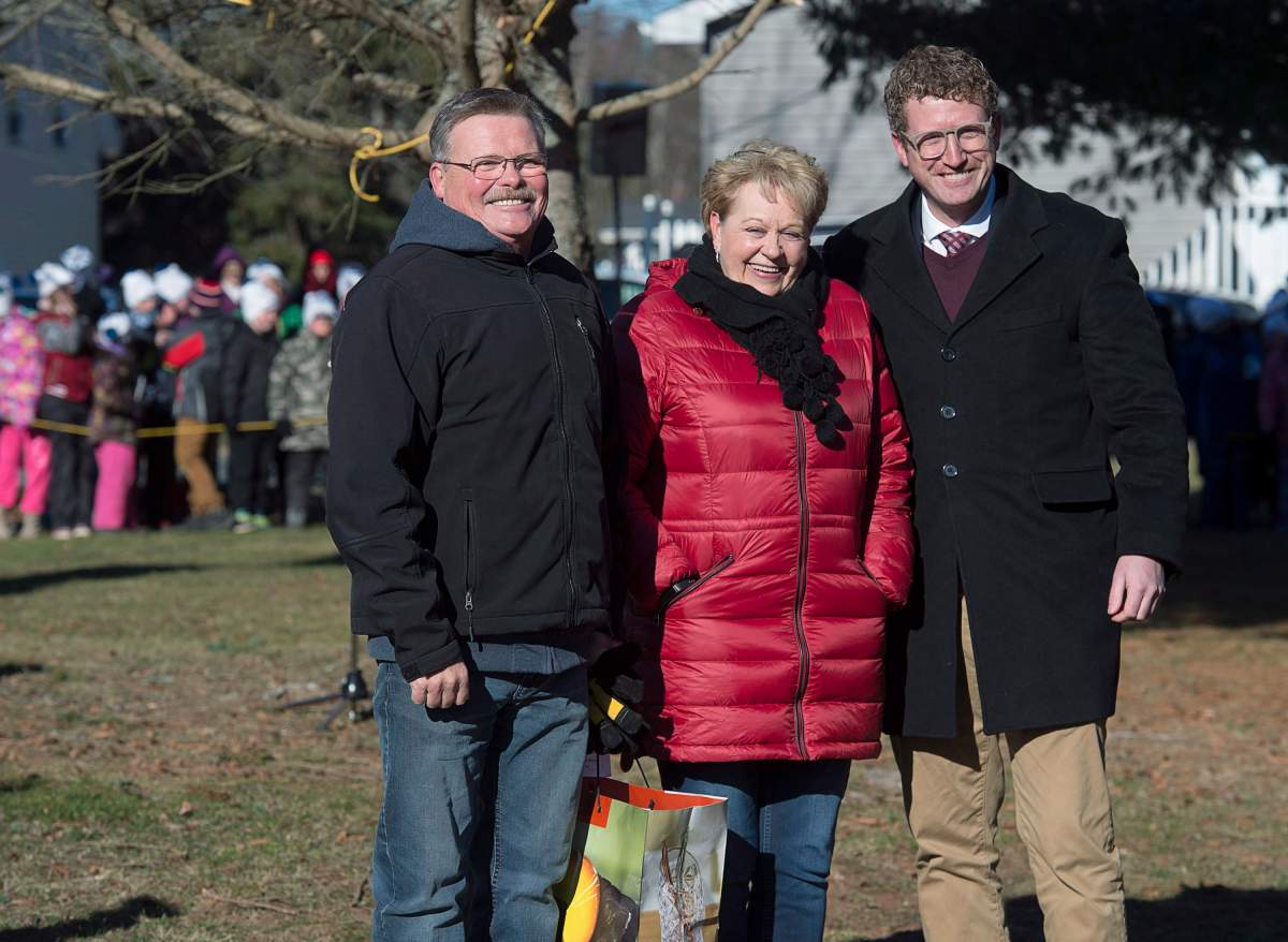 Iain Rankin, right, minister of Lands and Forestry, along with residents Ross McKellar and Teresa Simpson, who donated the 14-metre white spruce, attend the tree cutting ceremony in Oxford, N.S. on Thursday, Nov. 15, 2018.