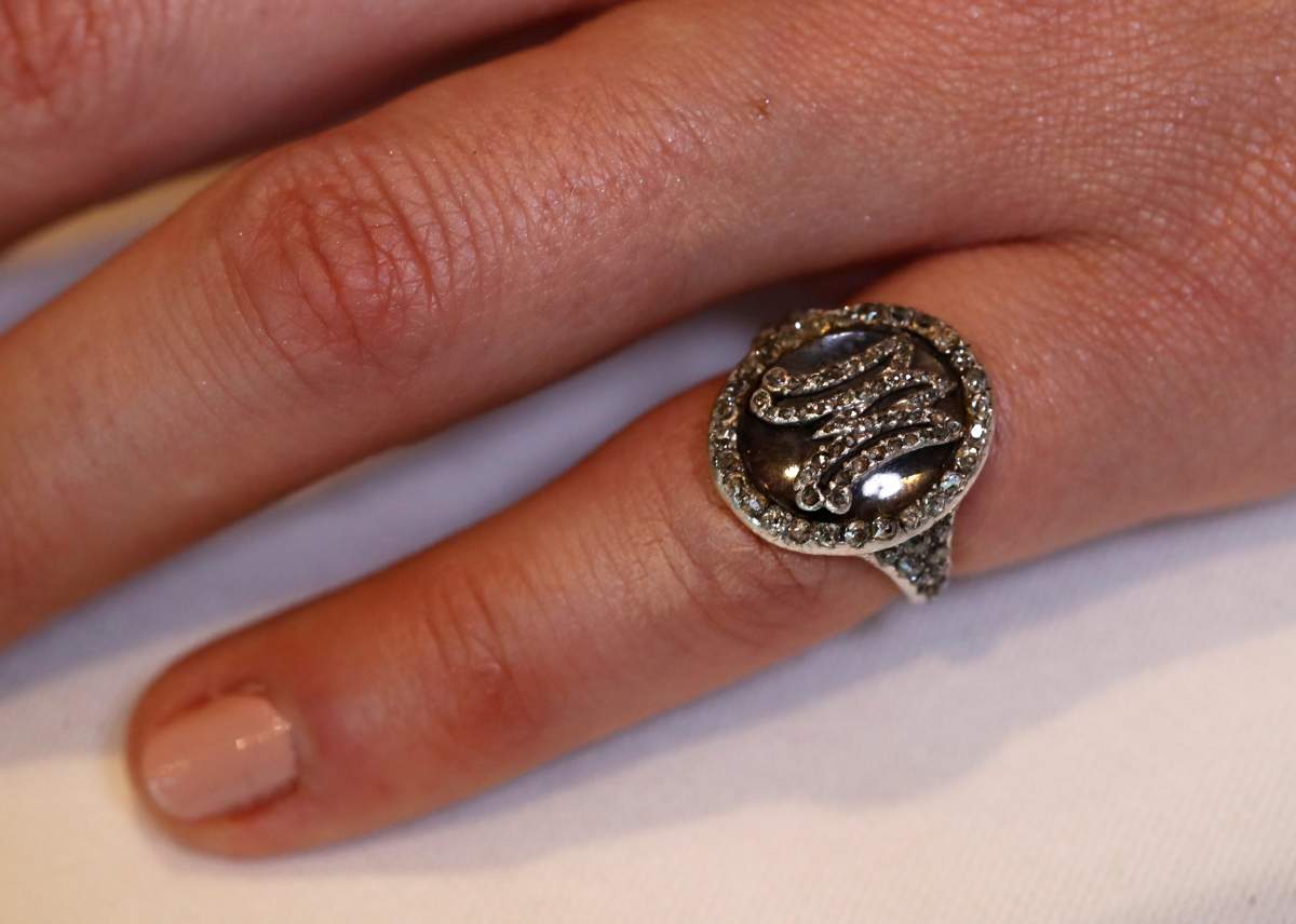 A model wears a diamond ring bearing the initials MA for Marie Antoinette and containing a lock of her hair during a press preview ahead of the upcoming auction “Royal jewels from the Bourbon Parma Family” at Sotheby’s in Geneva November 7, 2018. REUTERS/Denis Balibouse