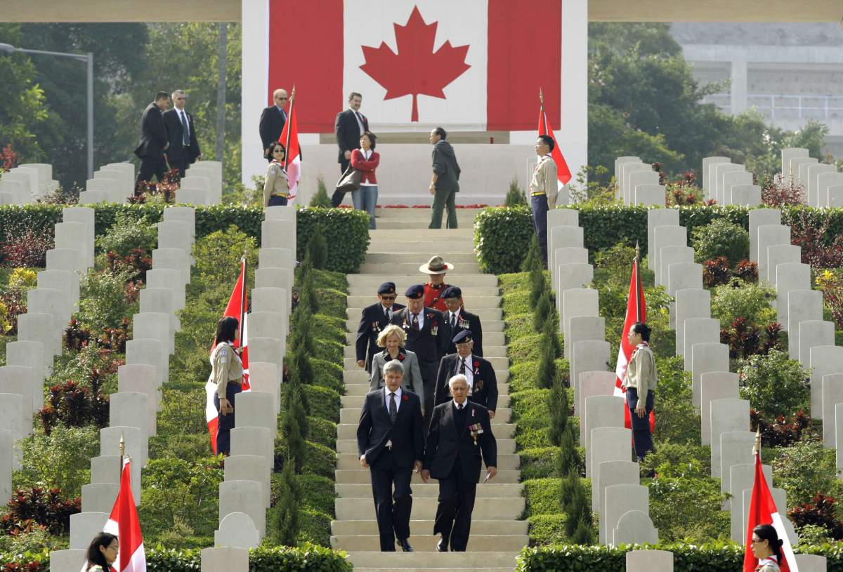 Canada’s Prime Minister Stephen Harper, front left, attends the commemoration ceremony at Sai Wan War Cemetery in Hong Kong Sunday, Dec. 6, 2009. The commemoration ceremony honours the 1,975 Canadian soldiers who fought to defend Hong Kong during the Second World War and remembers over 550 Canadian soldiers who died in battle. (AP Photo/Kin Cheung)