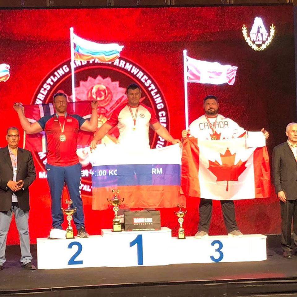 Ryan Espey, right, poses after his bronze medal win at the 2018 World Armwrestling Championship.