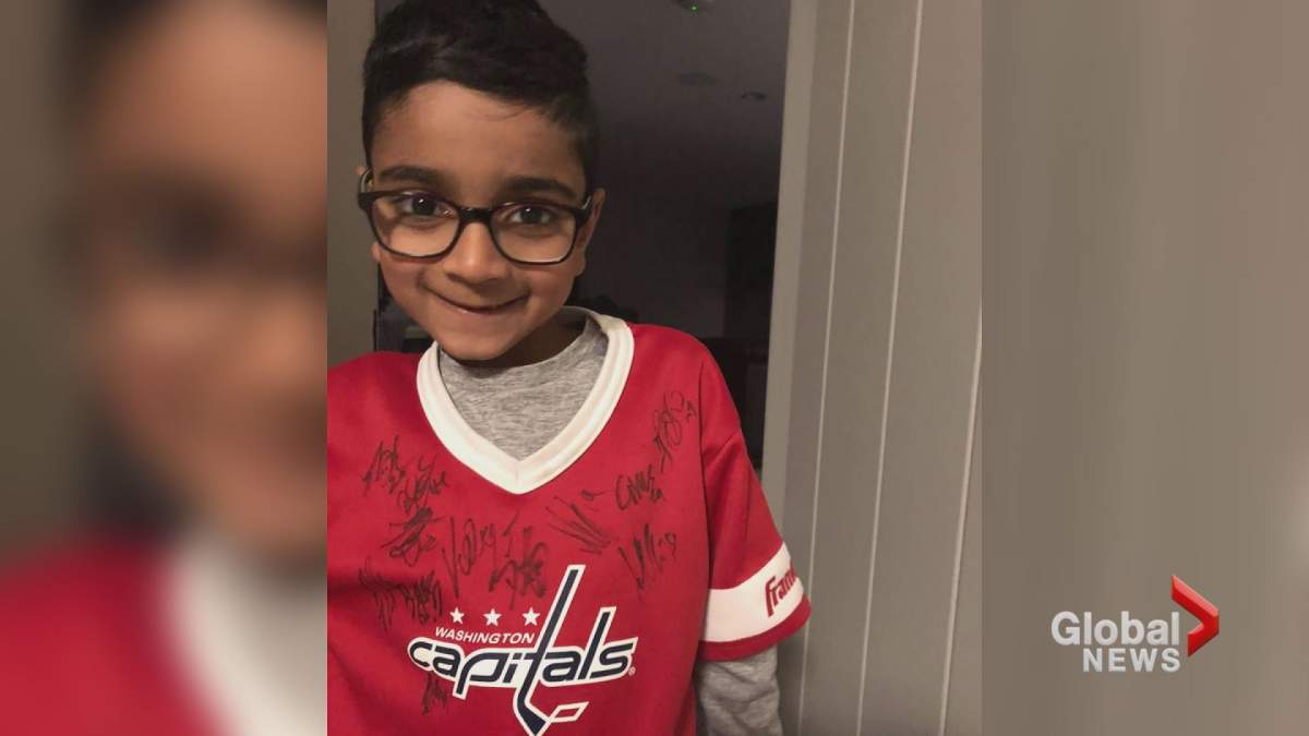 Aydin Ali is pictured with his signed Washington Capitals jersey.