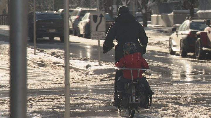 Natalie Sit rode with her daughter in tow through Eau Claire on Sunday morning.