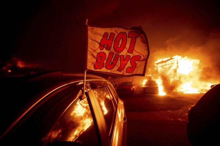 Flames consume a car dealership as the Camp Fire tears through Paradise, Calif., on Thursday, Nov. 8, 2018.