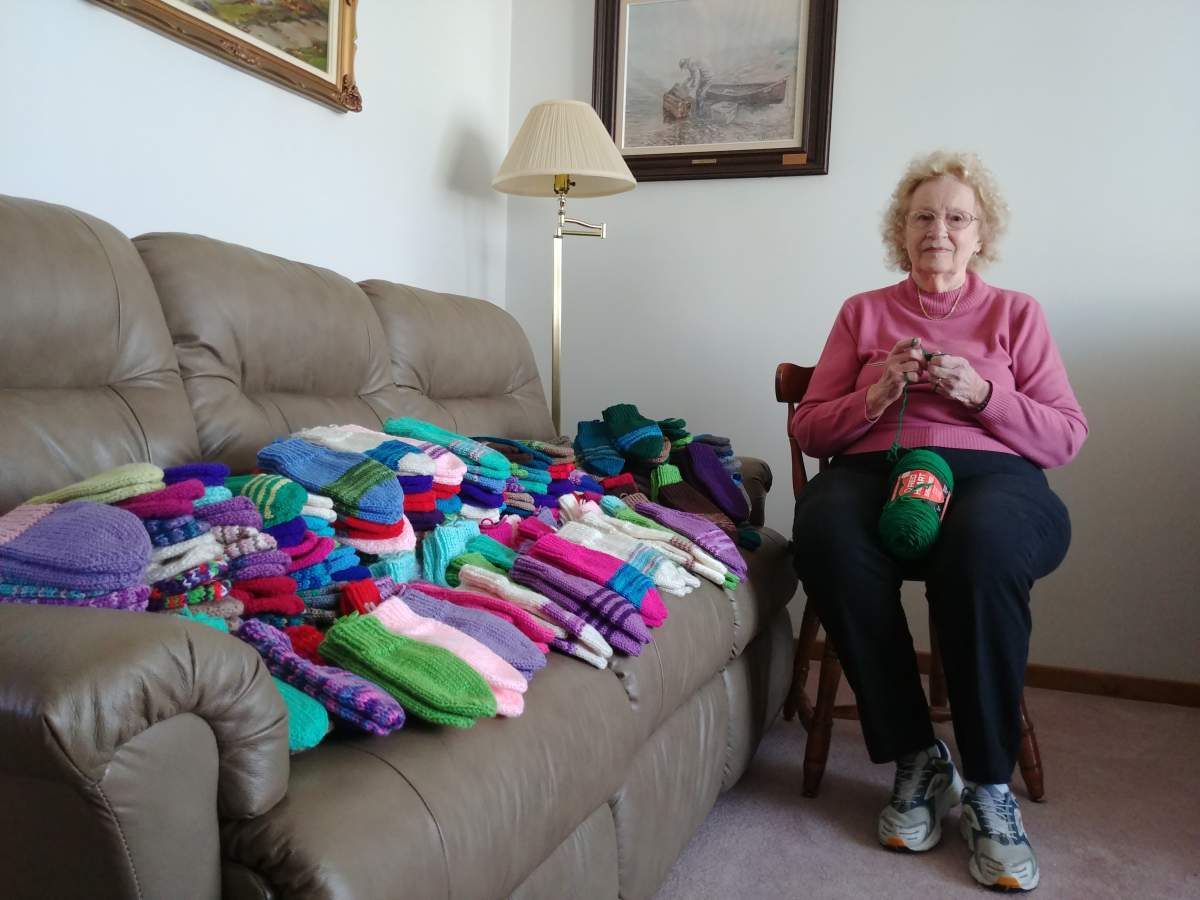 Celia Glover hand-knits mittens for Kingston Clothes for Kids campaign. She has donated 800 mitts to the Corus since 2012.