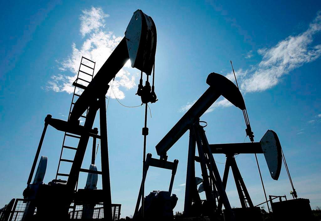 Pumpjacks are shown pumping crude oil near Halkirk, Alta., on June 20, 2007.