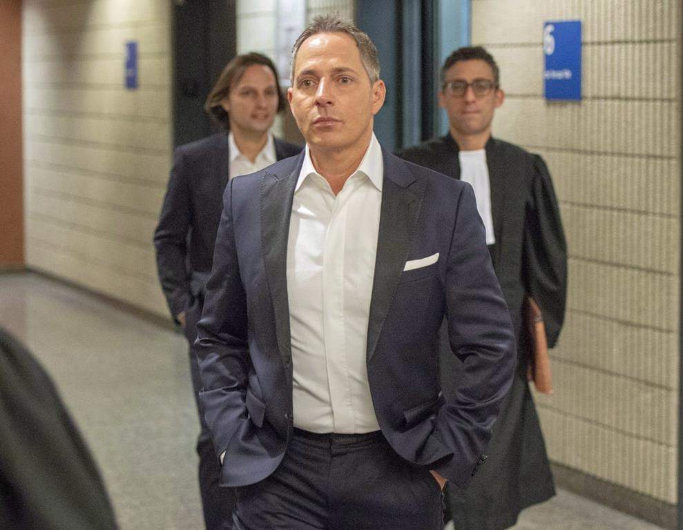 Yanai Elbaz, front, and his brother Yohann Elbaz, left, arrive for their fraud trial at the courthouse in relation to the MUHC hospital Monday, November 26, 2018 in Montreal.