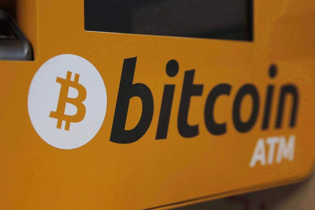 A Bitcoin logo is displayed on an ATM.