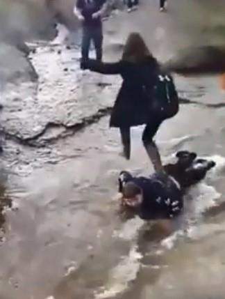 Advocates say a disturbing video showing a Cape Breton teen's classmates walking over him in a stream demonstrates how the lives of people with disabilities are often devalued. A screengrab from the video posted to Facebook is shown in a handout.
