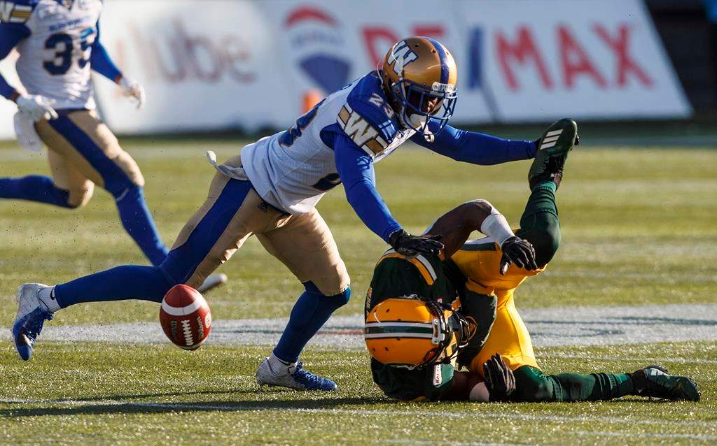 Winnipeg Blue Bombers Anthony Gaitor (23) tackles Edmonton Eskimos Godfrey Onyeka (23) during first half CFL action in Edmonton, Alta., on Saturday November 3, 2018. THE CANADIAN PRESS/Jason Franson.