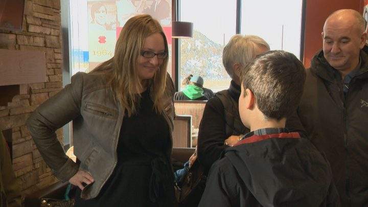 Dionne Miazdyck-Shield, executive director of the Saskatoon Society for the Protection of Children, talks with Eli Kearley.