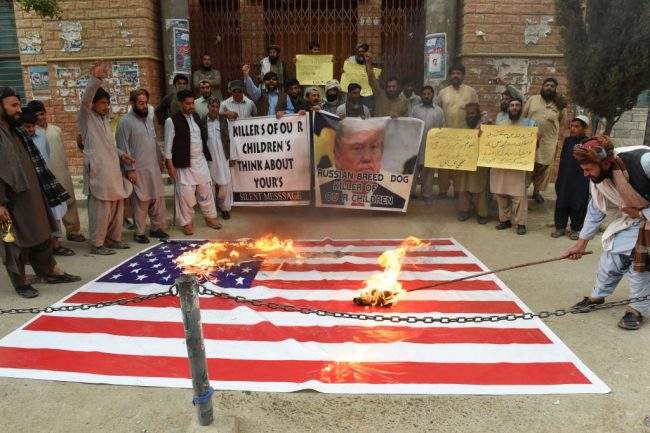 Pakistani protesters burn a U.S. flag during a protest against a U.S. airstrikeduring a demonstration against a US airstrike in Afghanistan in Quetta on April 3, 2018.