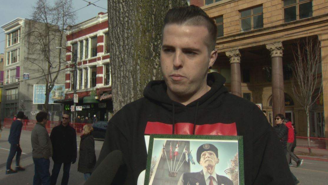 Markus McNeilly with a photo of his grandfather Art Leggett.