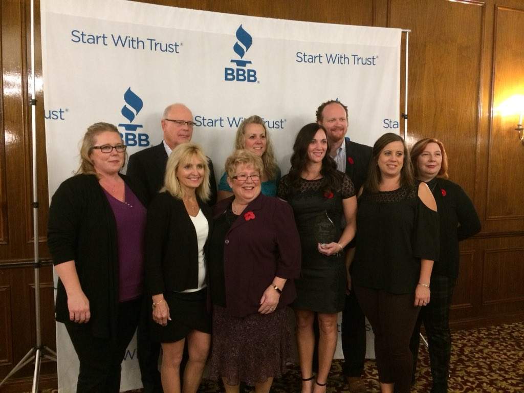 James and Victoria Chalmers stand with some of their staff, after winning a Business Integrity Award for Home Instead Senior Care.