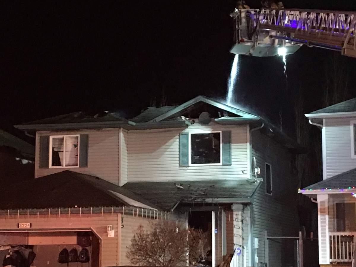 Crews put out hot spots at a home in the Silver Berry neighbourhood.