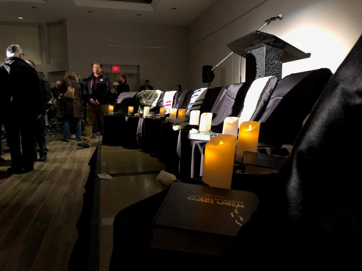 Eleven candles lay lit by the stage of the London Jewish Community Centre, in honour of the 11 people killed in the Pittsburgh synagogue shooting.