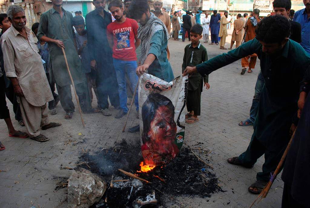 Protesters burn an image of Christian woman Asia Bibi in Hyderabad, Pakistan, Thursday, Nov. 1, 2018.