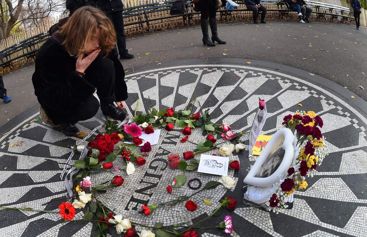 Emma Bassant from Toronto places flowers at Strawberry Fields in New York City on Dec. 8, 2015.