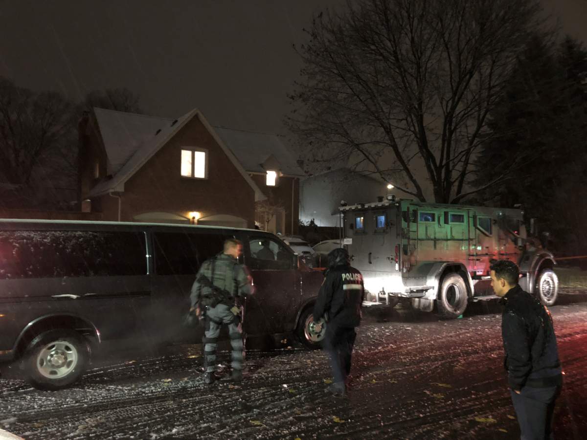 Montreal police officers outside a home in Kirkland following a shooting.