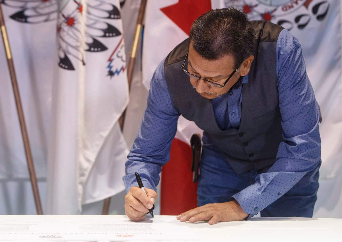 Lubicon Lake First Nation Chief Billy Joe Laboucan signs a historic land deal, in Little Buffalo, Alta. on Tuesday November 13, 2018.