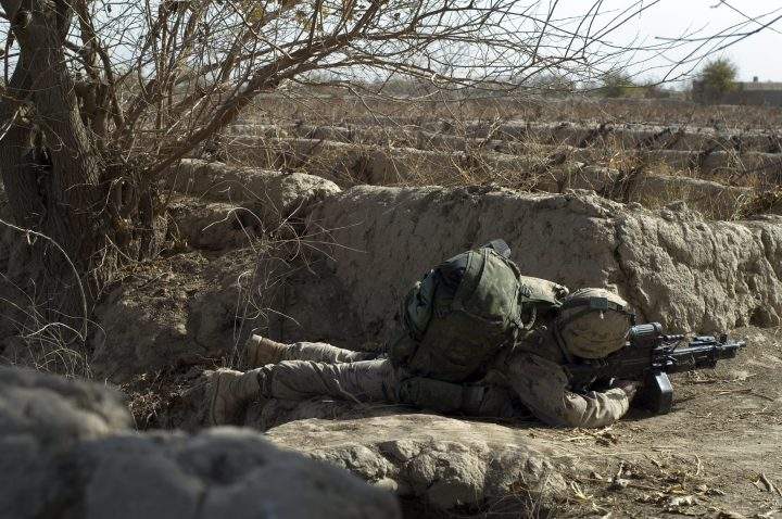 In this Dec. 4, 2007 file photo, a Canadian soldier with a machine gun covers a line of advance during an operation in the Zharey-Panjwaii area where Canadian troops were later ambushed.