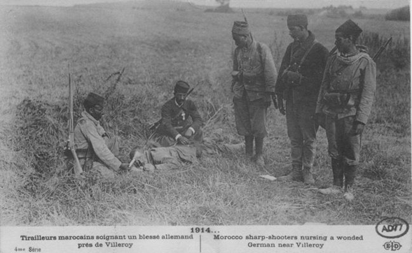 Moroccan soldiers nurse a wounded German prisoner-of-war near Villeroy in north-central France