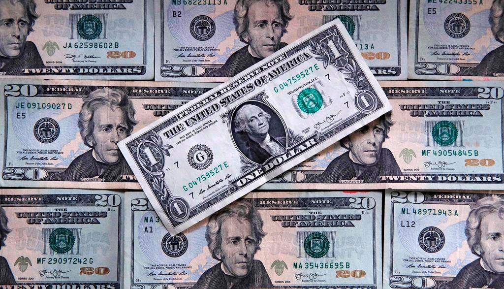 FILE- This June 15, 2018, file photo shows U.S. currency on a counter in East Derry, N.H. Most financial planners advise never tapping retirement savings to pay for your kid‚Äôs education. Even as college costs climb, there are still options to borrow that cash, whereas it's often noted that you can‚Äôt borrow for retirement. (AP Photo/Charles Krupa, File).