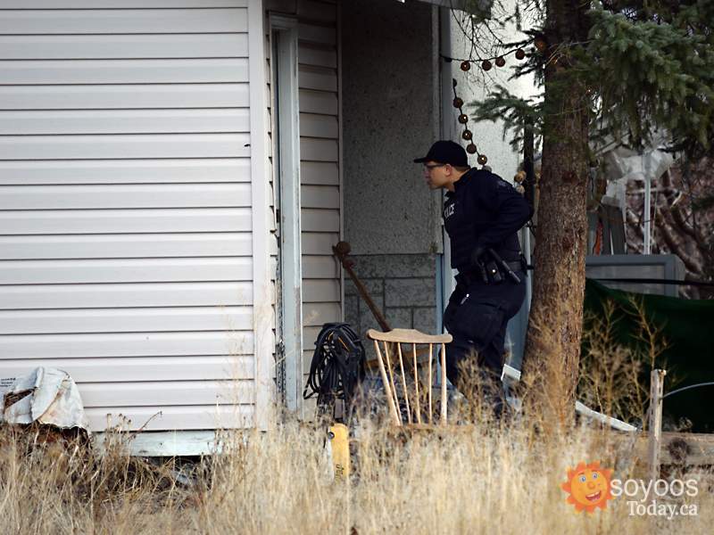 A police officer searches the scene.