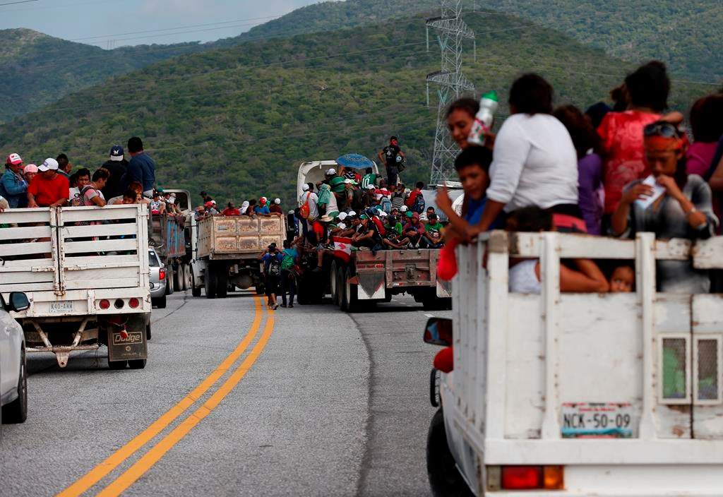 Migrants hitch rides in the back of trucks as the thousands-strong caravan of Central Americans hoping to reach the U.S. border moves onward from Juchitan, Oaxaca state, Mexico, Thursday, Nov. 1, 2018.