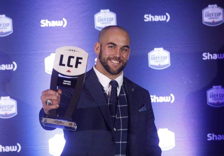 Winner of the Tom Pate award, Edmonton Eskimos’ Ryan King, holds his award during the Shaw CFL Awards in Edmonton on Thursday, Nov. 22, 2018.