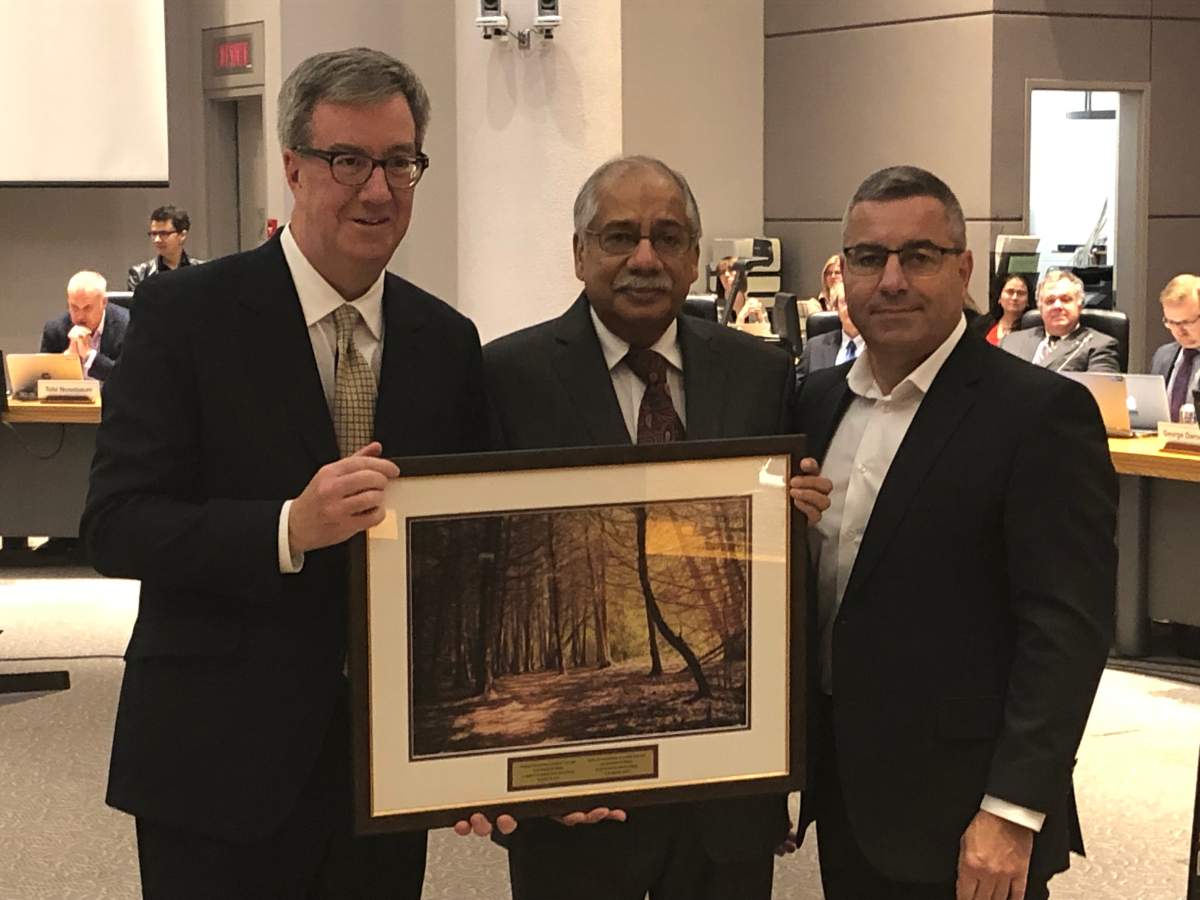 Shad Qadri (centre) was the city councillor for Stittsville for last 12 years. Ottawa Mayor Jim Watson (left) and city manager Steve Kanellakos (right) recognized Qadri, who was defeated in October's municipal election, for his public service during the final city council meeting of the term on Nov. 28, 2018.
