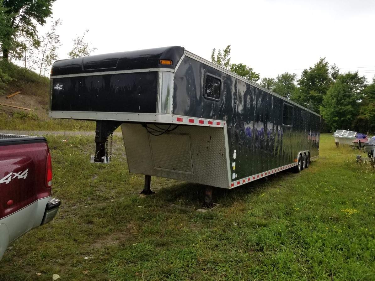This trailer containing two race cars was stolen.