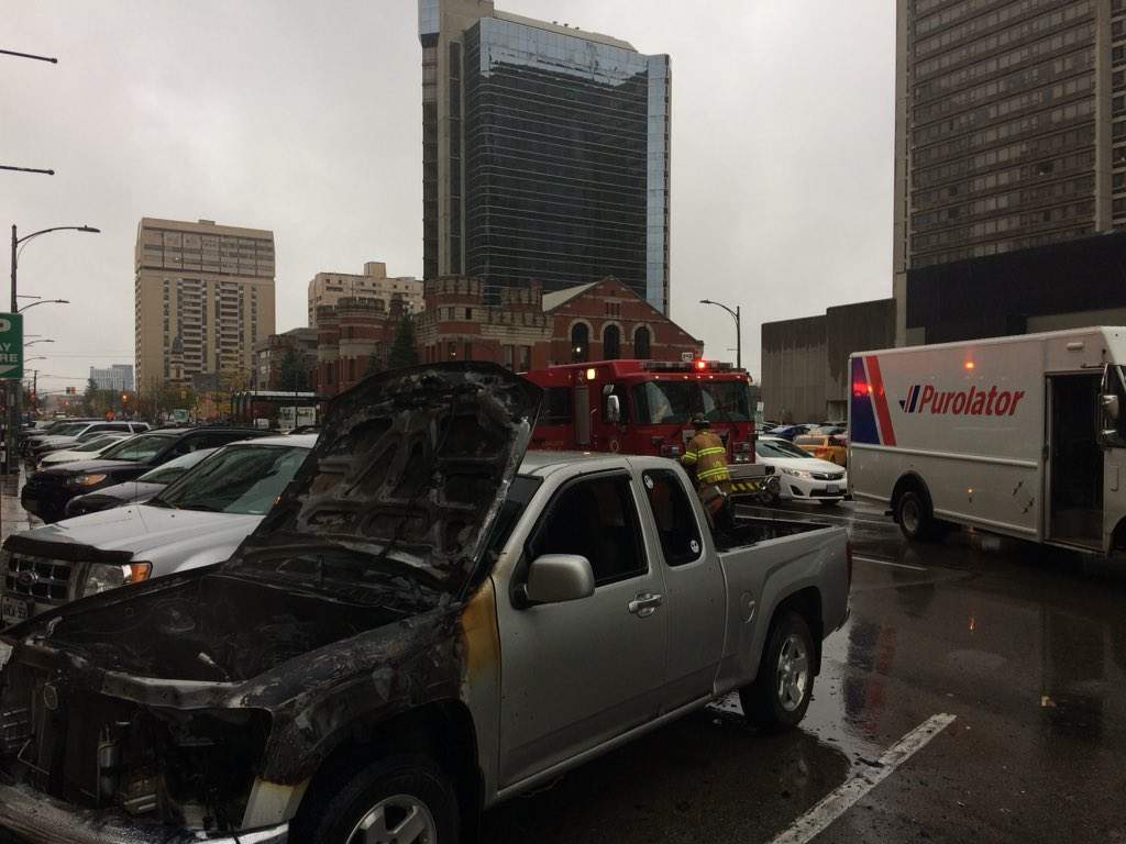 A truck continues to smoulder after bursting into flames in downtown London on Thursday, Nov. 1, 2018.