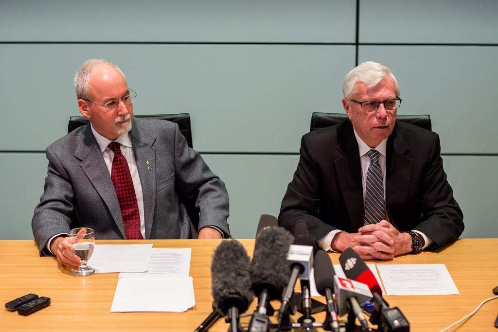 Sergeant-at-Arms Gary Lenz (L) and Clerk of the Legislative Assembly Craig James make a statement to media in Vancouver, B.C., on Monday November 26, 2018. THE CANADIAN PRESS/Ben Nelms
