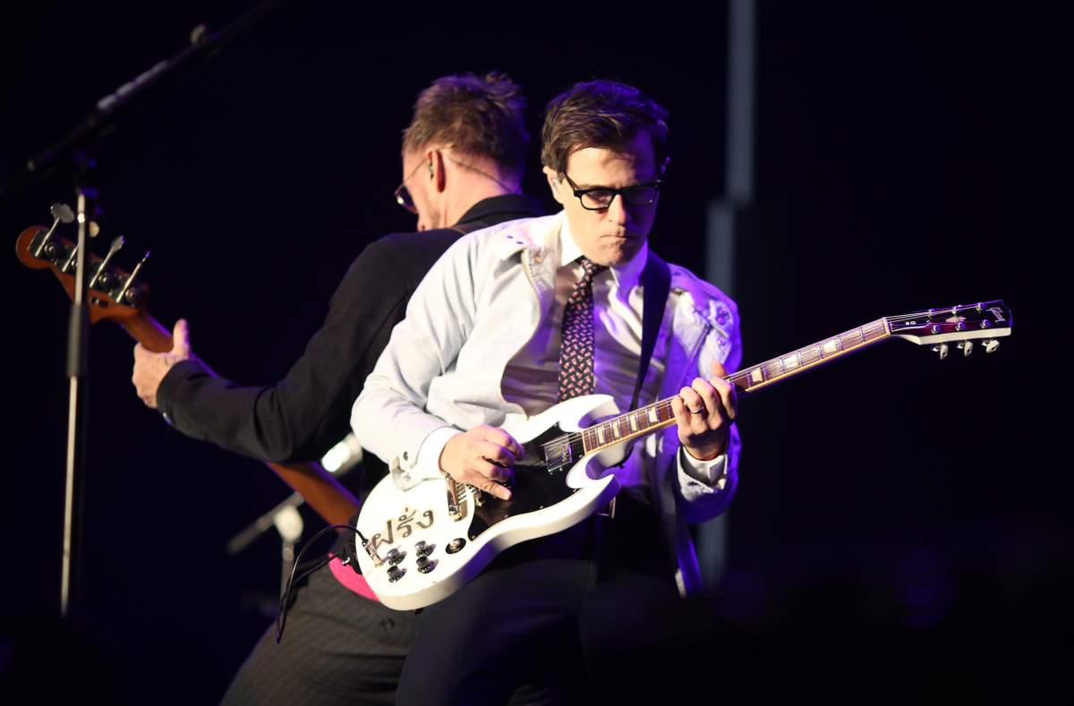Scott Shriner, left, and Rivers Cuomo of Weezer perform onstage during KROQ Almost Acoustic Christmas 2017 at The Forum on Dec. 10, 2017 in Inglewood, Calif.